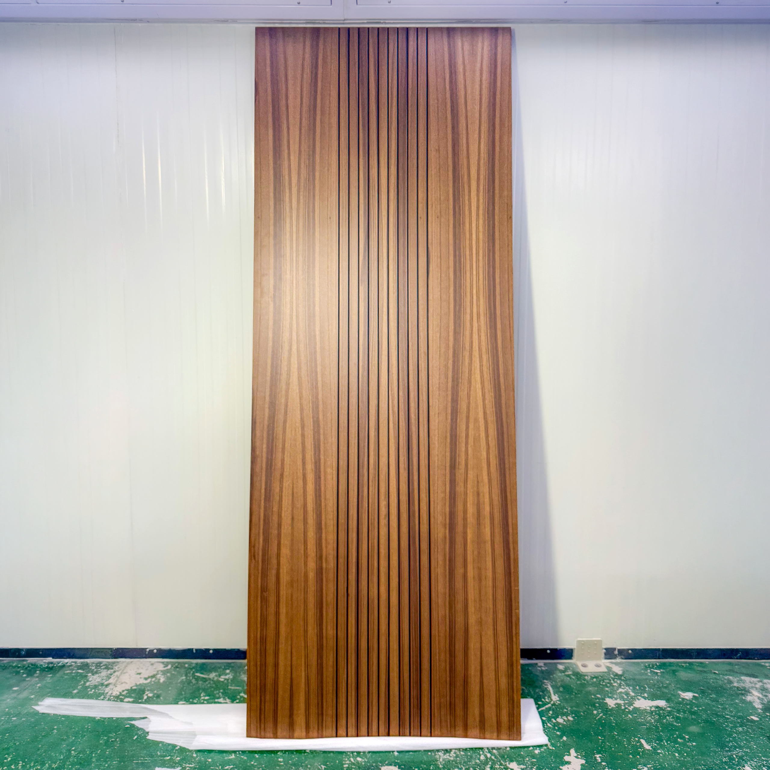 Grooved teak veneer flush door with solid core, made by LK Doors and Interiors for a residential building in Delhi