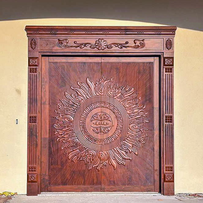 Carved solid teak double entrance door with custom carved frame and architrave, installed on a house in Texas